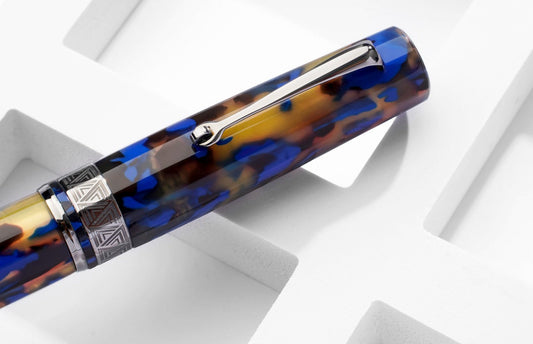 New OMAS Paragon fountain pen with faceted body, blue resin, and chrome details.