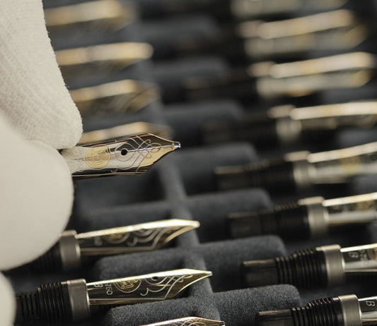 Pelikan fountain pen nibs on quality control rack.