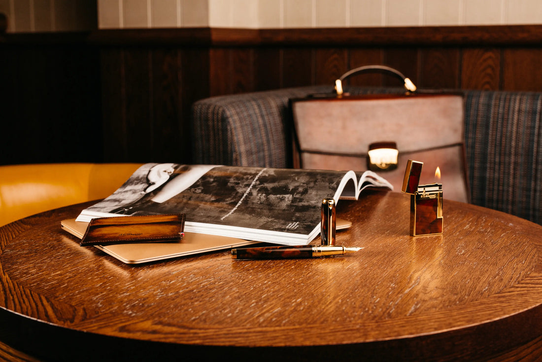 Mixed S.T. Dupont luxury products shown on a brown table.