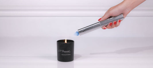 S.T. Dupont candle lighter The Wand being used to light a candle.