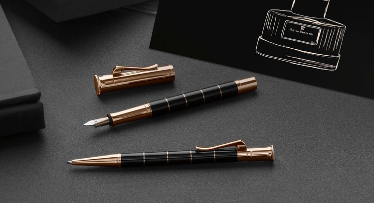 Graf von Faber-Castell Classic anello pens with black barrels and rose gold accents.