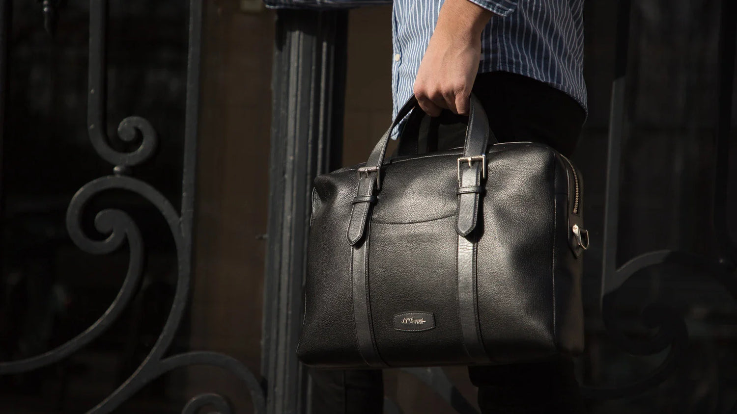 Man carrying black soft leather document holder from S.T. Dupont 