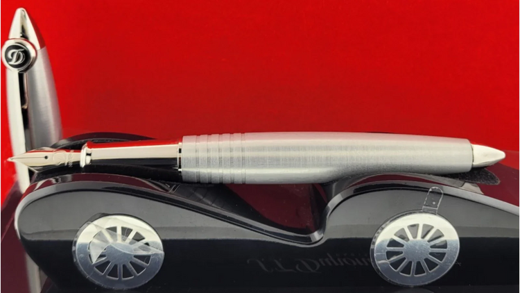 Brushed palladium S.T. Dupont fountain pen displayed on a model car, previously sold by Art Brown International.