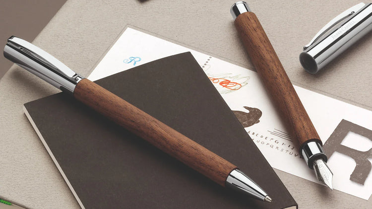 Faber-Castell ambition fountain and ballpoint pens with walnut wood barrels and chrome accents