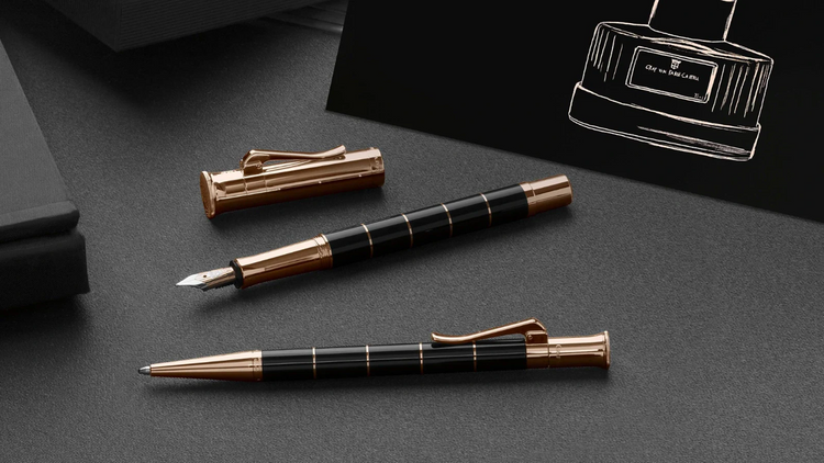Graf von Faber-Castell Classic anello pens with black barrels and rose gold accents.