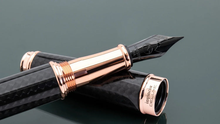 Monteverde invincia deluxe fountain pen with carbon fiber barrel, rose gold accents, and black pvd nib