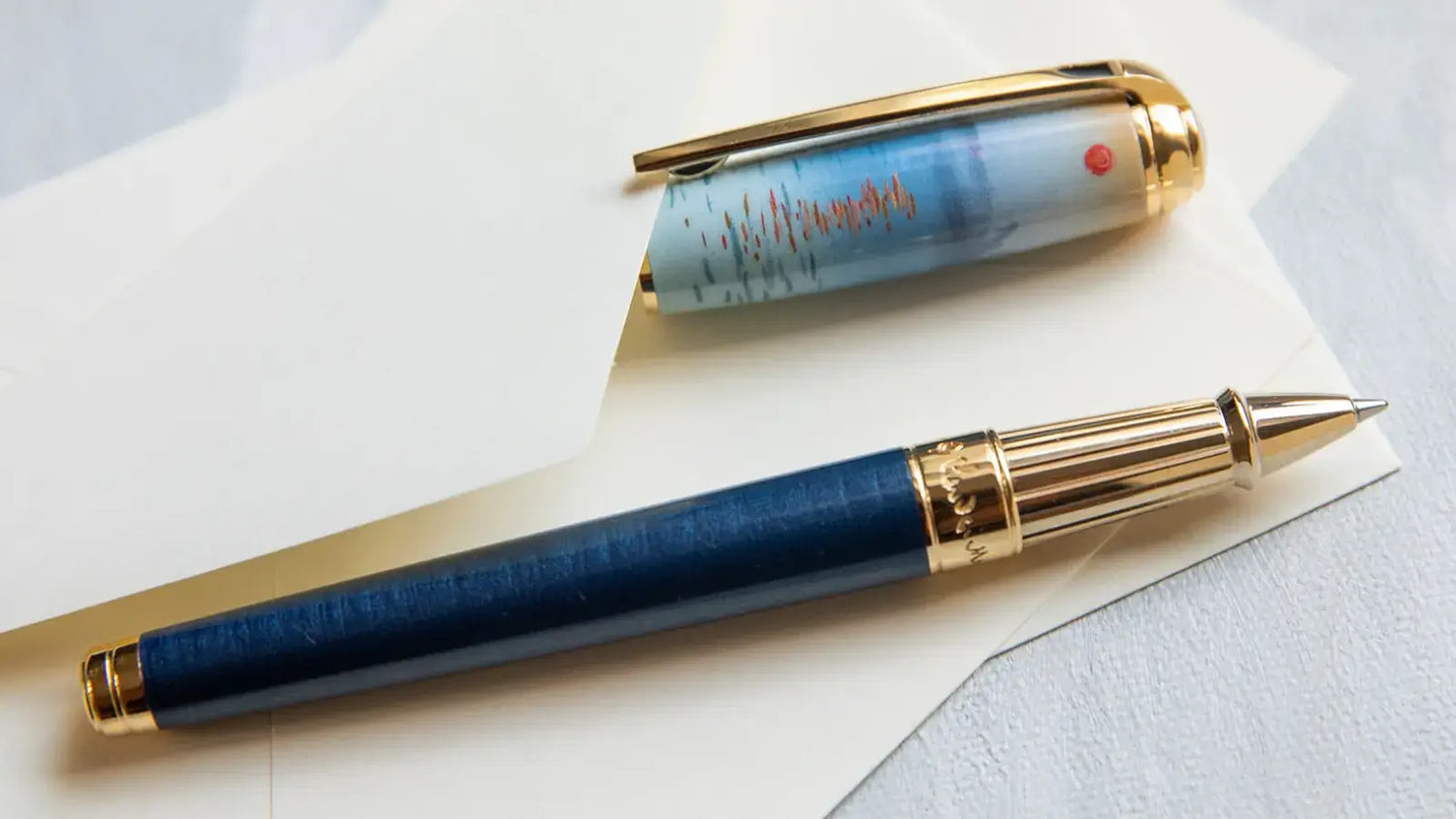 S.T. Dupont Limited Edition Claude Monet Impression Sunrise rollerball pen with pearlescent blue lacquer and gold accents