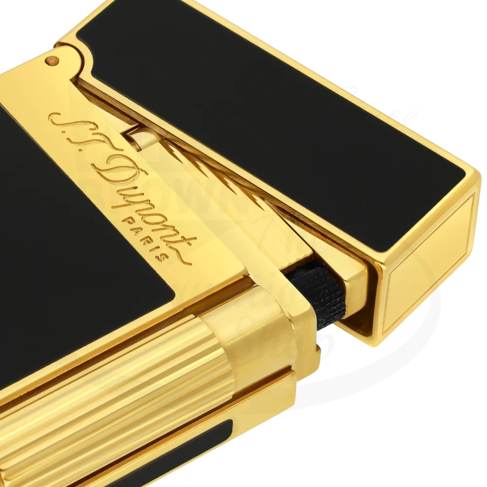 Corner of S.T. Dupont ligne 2 lighter with shiny black lacquer and gold accents.