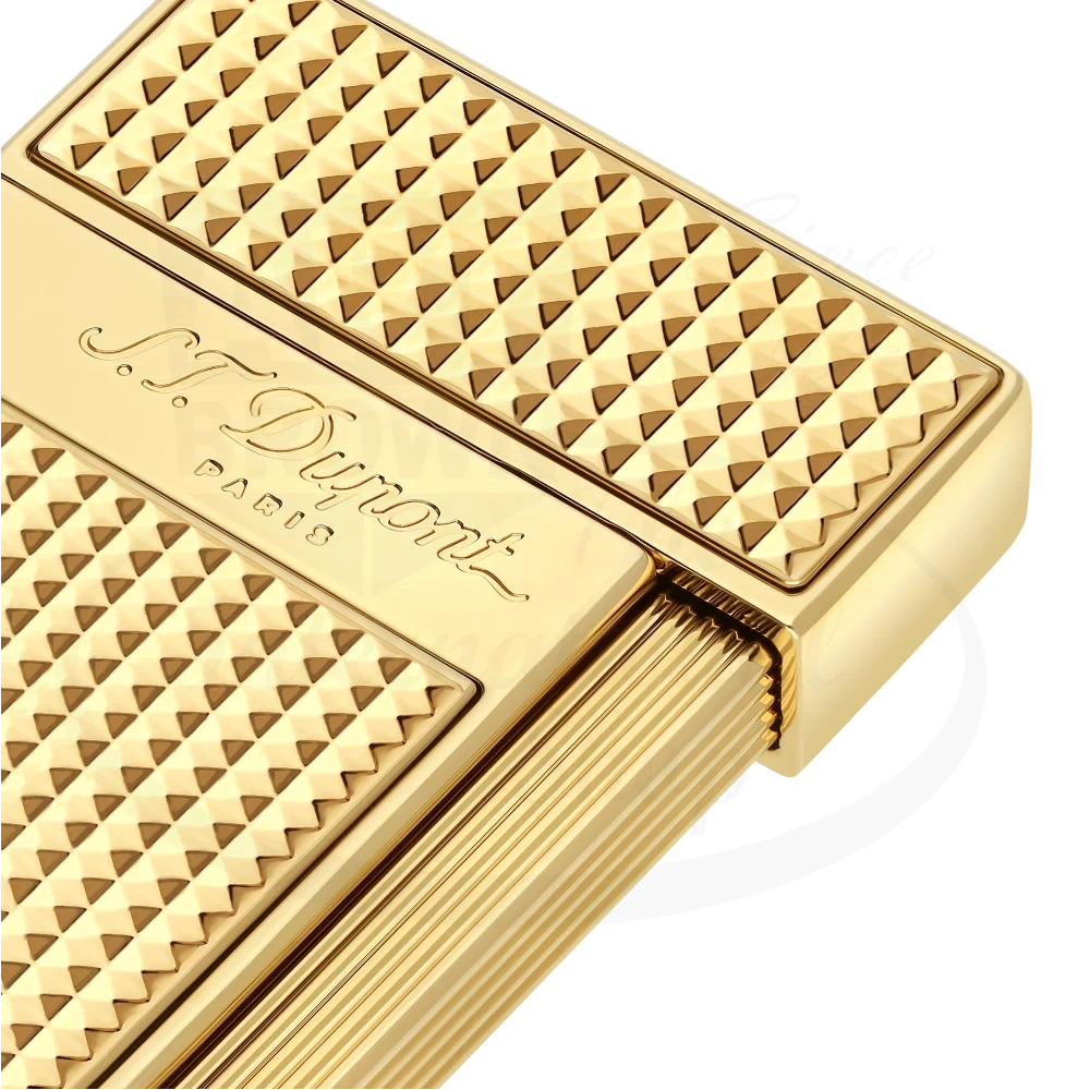 Corner of S.T. Dupont slimmy torch lighter with diamond head pattern in gold 