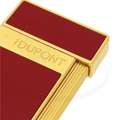 Close up view of S.T. Dupont slimmy lighter with red lacquer and gold finish.