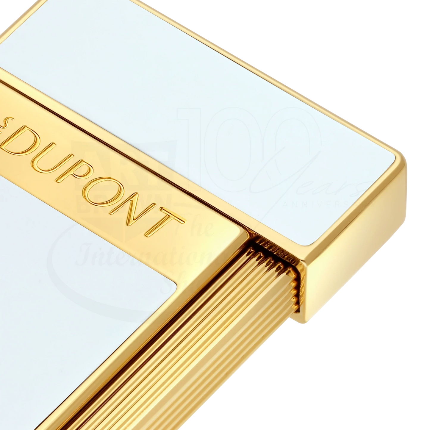 Close-up of S.T. Dupont slimmy white lacquer and gold lighter with elegant engraved branding and textured trigger design