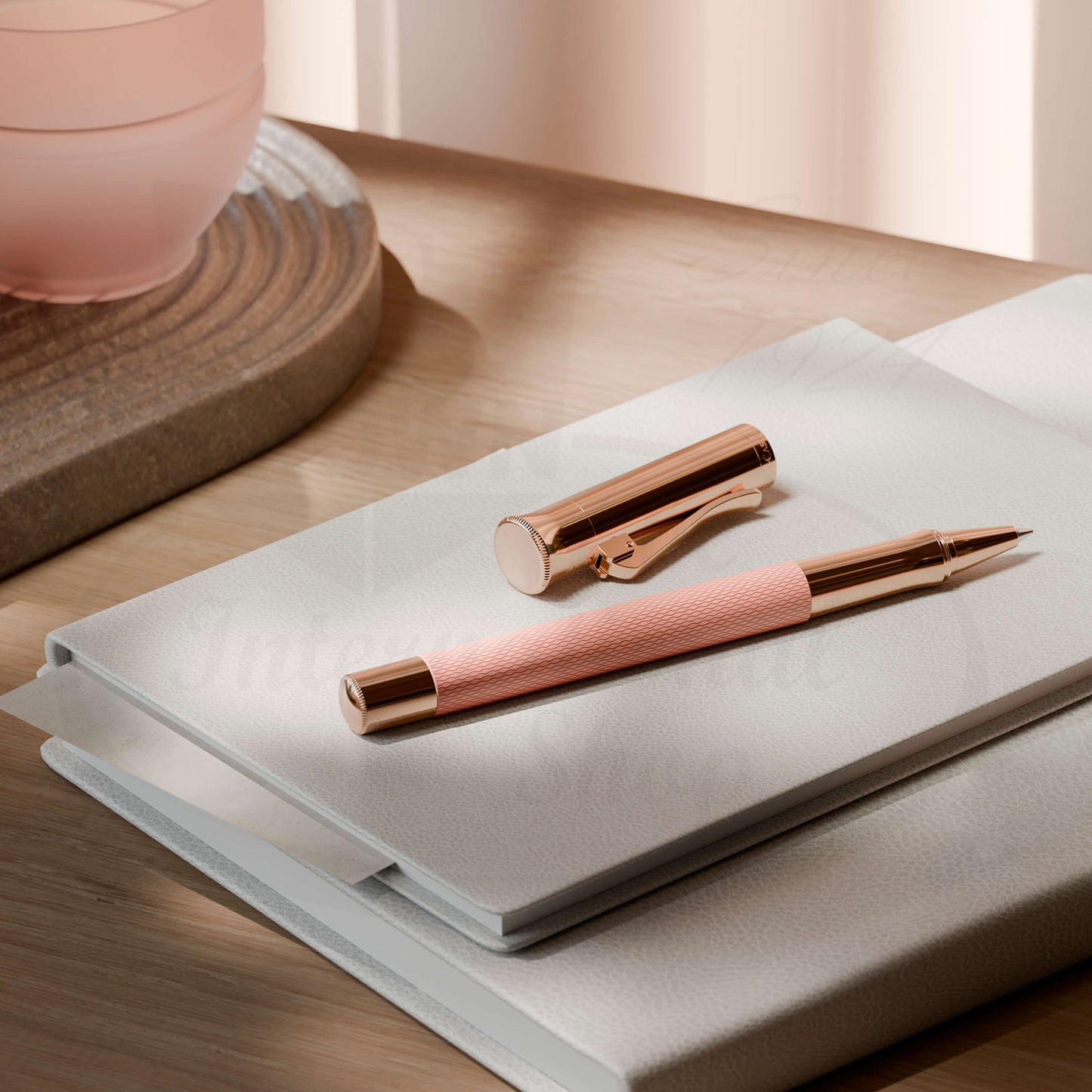 Graf von Faber-Castell Guilloche Rose Gold rollerball pen with pink resin barrel and engraved guilloché pattern