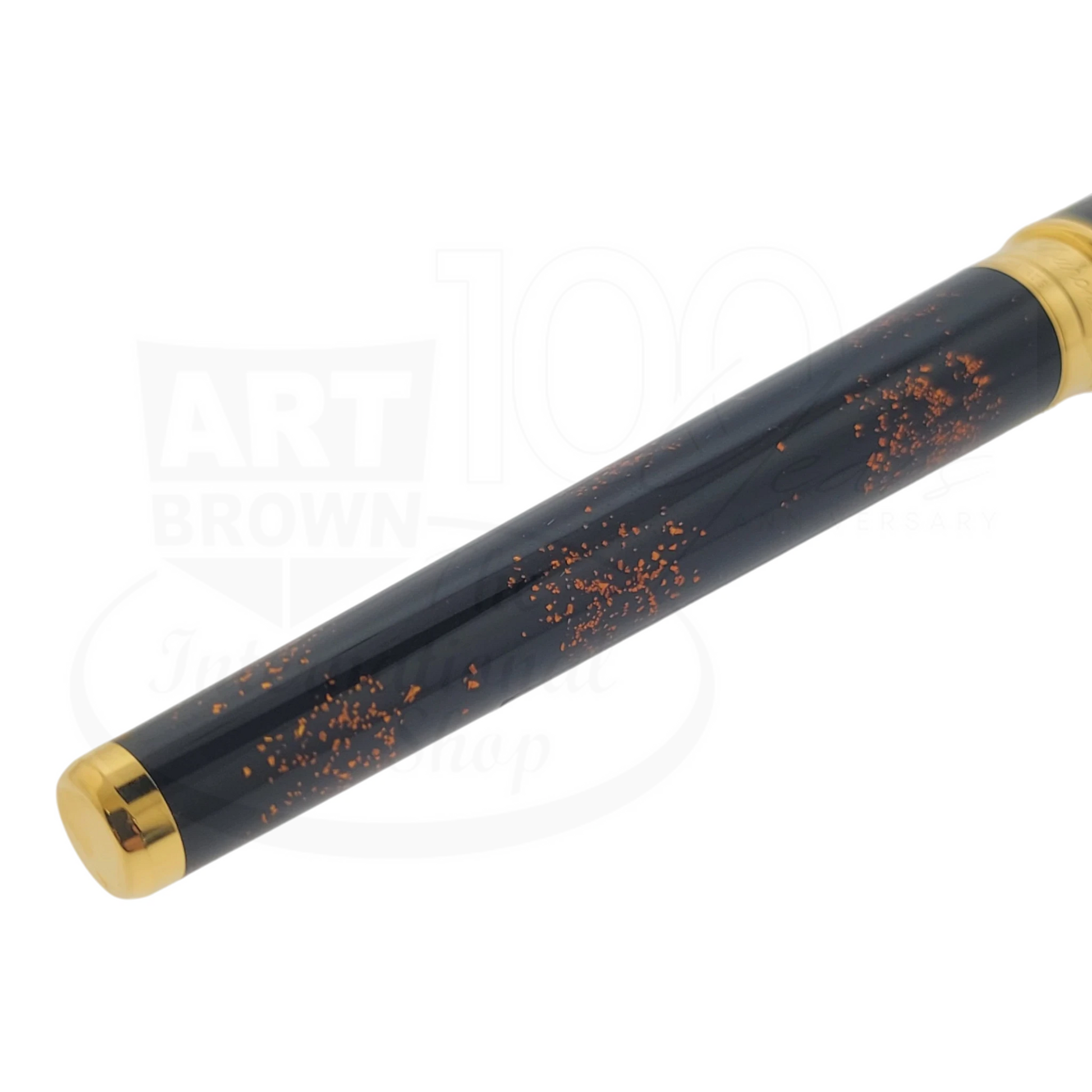 S.T. Dupont Olympio 482590 rollerball pen with black lacquer, scattered gold dust accents, and polished gold trim close-up