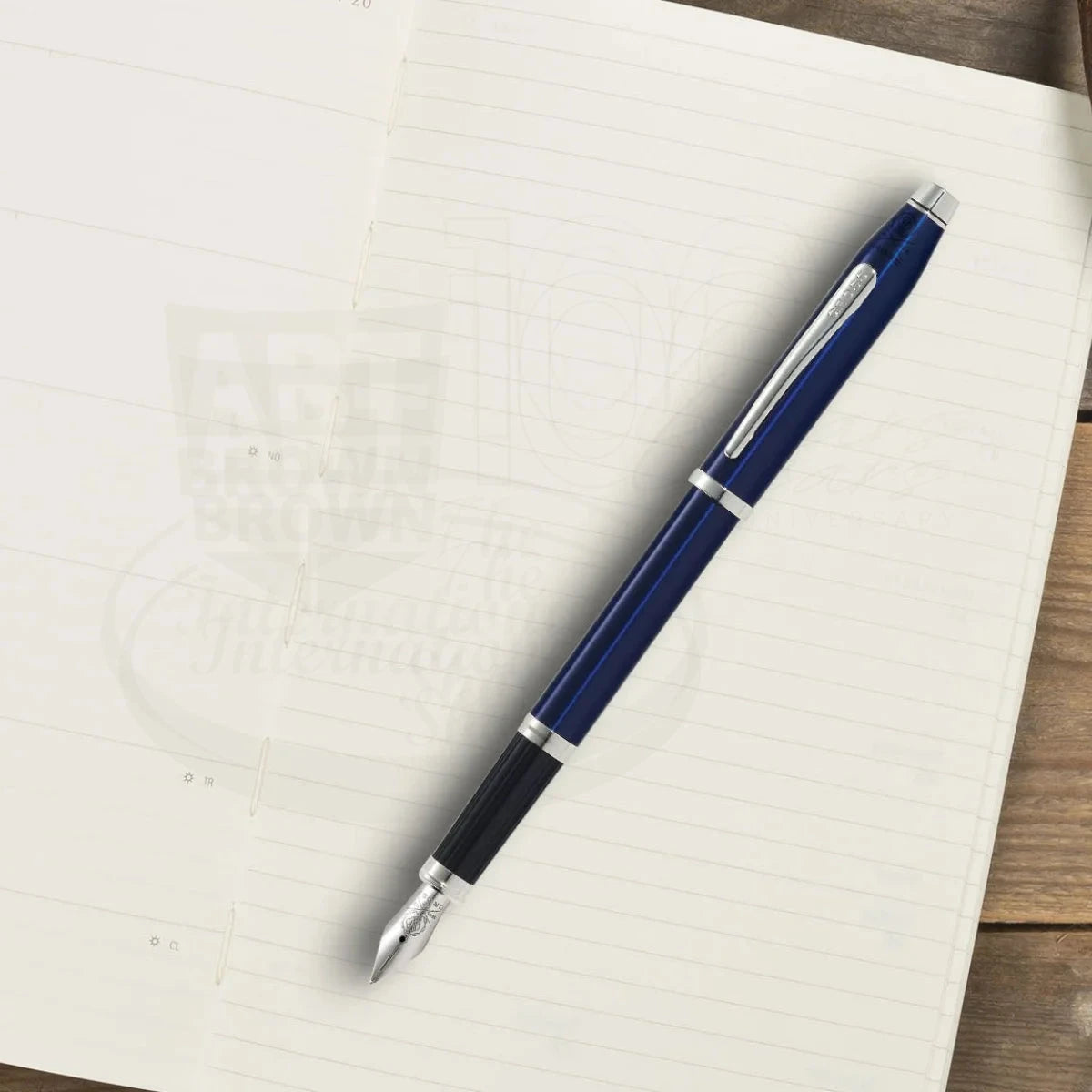 Century® II Translucent Blue Lacquer Fine Nib Fountain Pen with blue lacquer barrel and silver accents resting on an open notebook