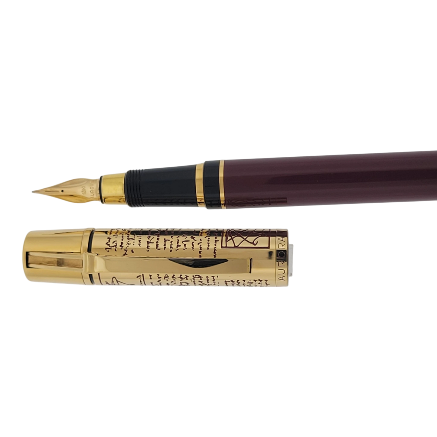 Preowned Aurora Limited Edition Leonardo Da Vinci Fountain Pen with gold cap featuring engraved script and burgundy barrel luxury pen