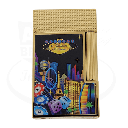 S.T. Dupont Ligne 2 C16396 brass lighter in gold finish with Las Vegas themed lacquer design featuring cityscape, dice and casino elements on black background