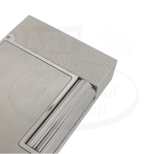 Close up of corner of S.T. Dupont Ligne 2 perfect ping lighter with brushed palladium finish and diamond head guilloche.