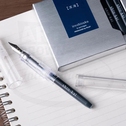 Pilot Iroshizuku 6-Pack cartridges with navy blue box and demonstrator fountain pen, showcasing elegant Japanese packaging and transparent ink chamber