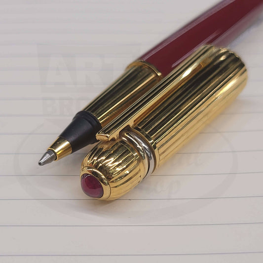Cartier Pasha Vintage rollerball pen with ruby top, gold-tone cap, and deep red lacquer barrel in excellent condition