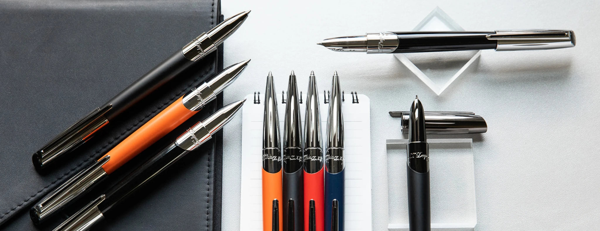 S.T. Dupont Defi Millennium rollerball, ballpoint and fountain pens, in a variety of finishes, red, orange, blue or black lacquer, with chrome of gunmetal accents