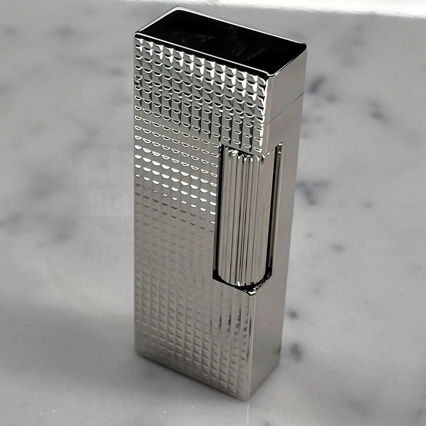 Dunhill Rollagas Hobnail Lighter with geometric hobnail pattern standing on marble, gallery position 11, 2048x2048 square image