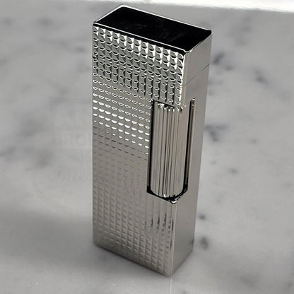 Dunhill Rollagas Hobnail Lighter with geometric hobnail pattern standing on marble, gallery position 11, 2048x2048 square image