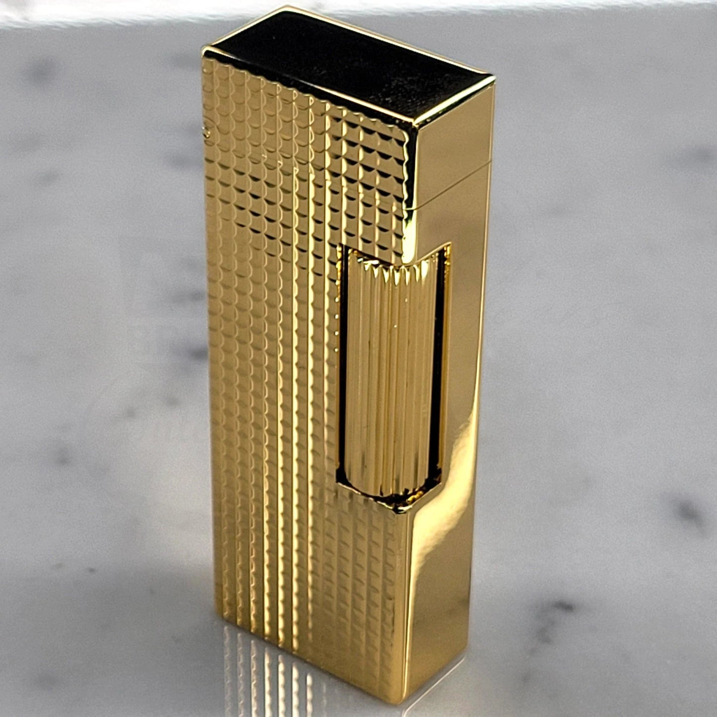 Dunhill Rollagas Hobnail Lighter in a close-up gallery 4 shot with detailed geometric hobnail brass surface.