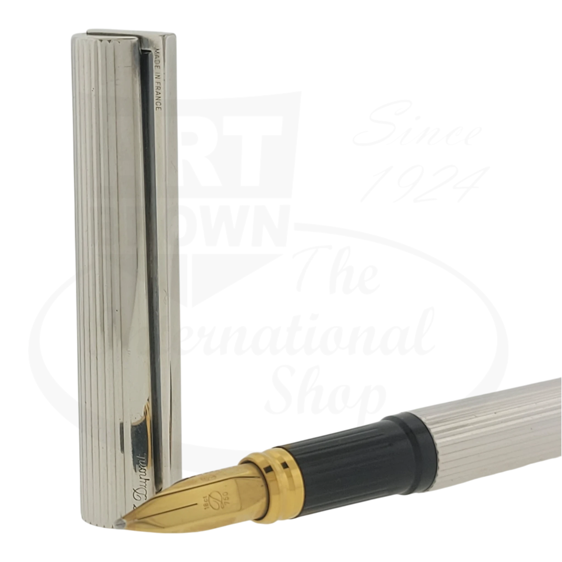 Preowned Vintage S.T. Dupont Classique Silver Vertical Lines pen with gold nib, black grip, and silver-plated barrel