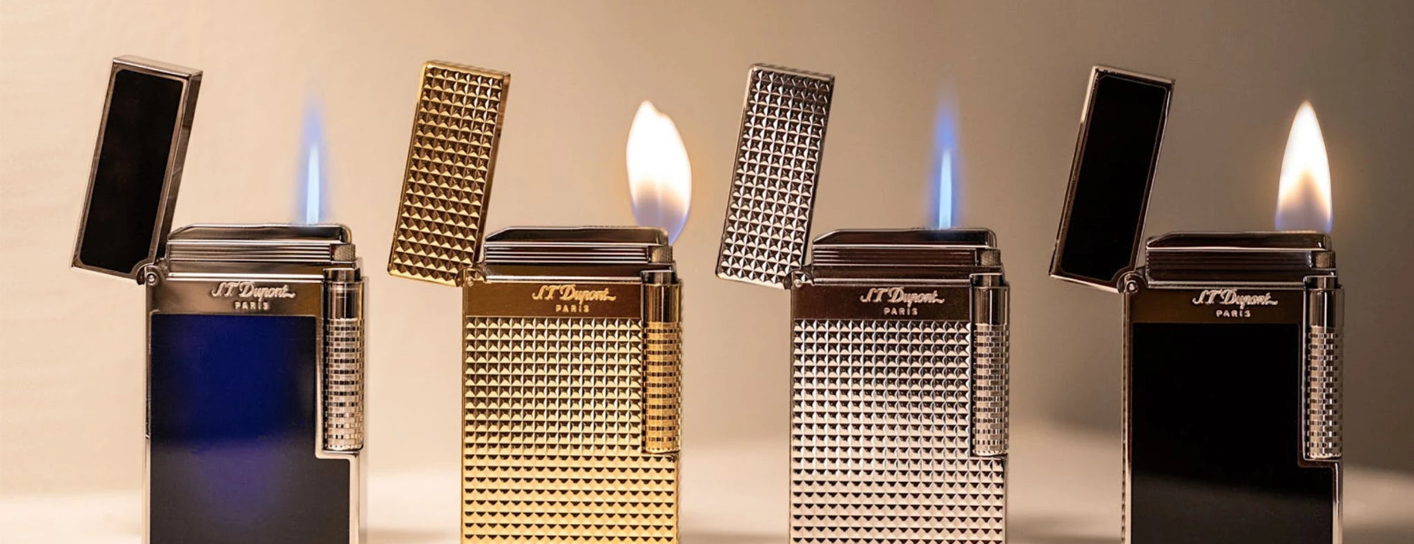 Four S.T. Dupont Le Grand lighters with different designs showcasing double soft flame and torch flame.