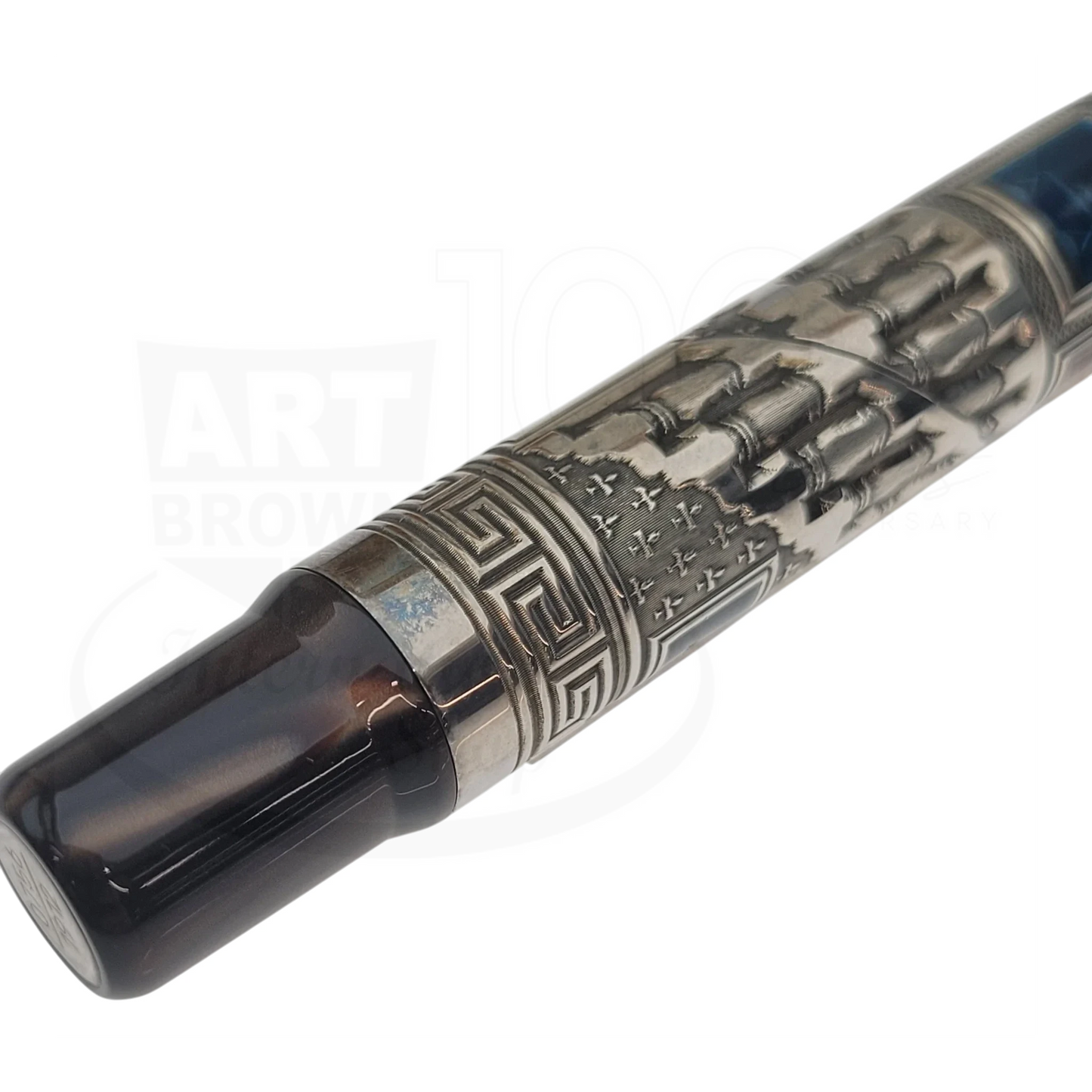 Close-up of a luxury fountain pen with intricate metal engravings and a dark resin grip section