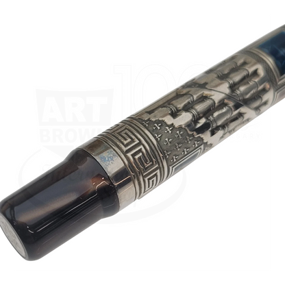 Close-up of a luxury fountain pen with intricate metal engravings and a dark resin grip section