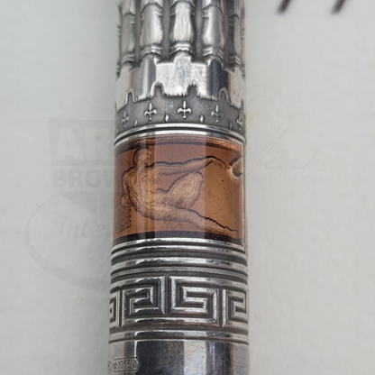 Close-up of an intricate silver and amber detailed section on a luxury fountain pen barrel