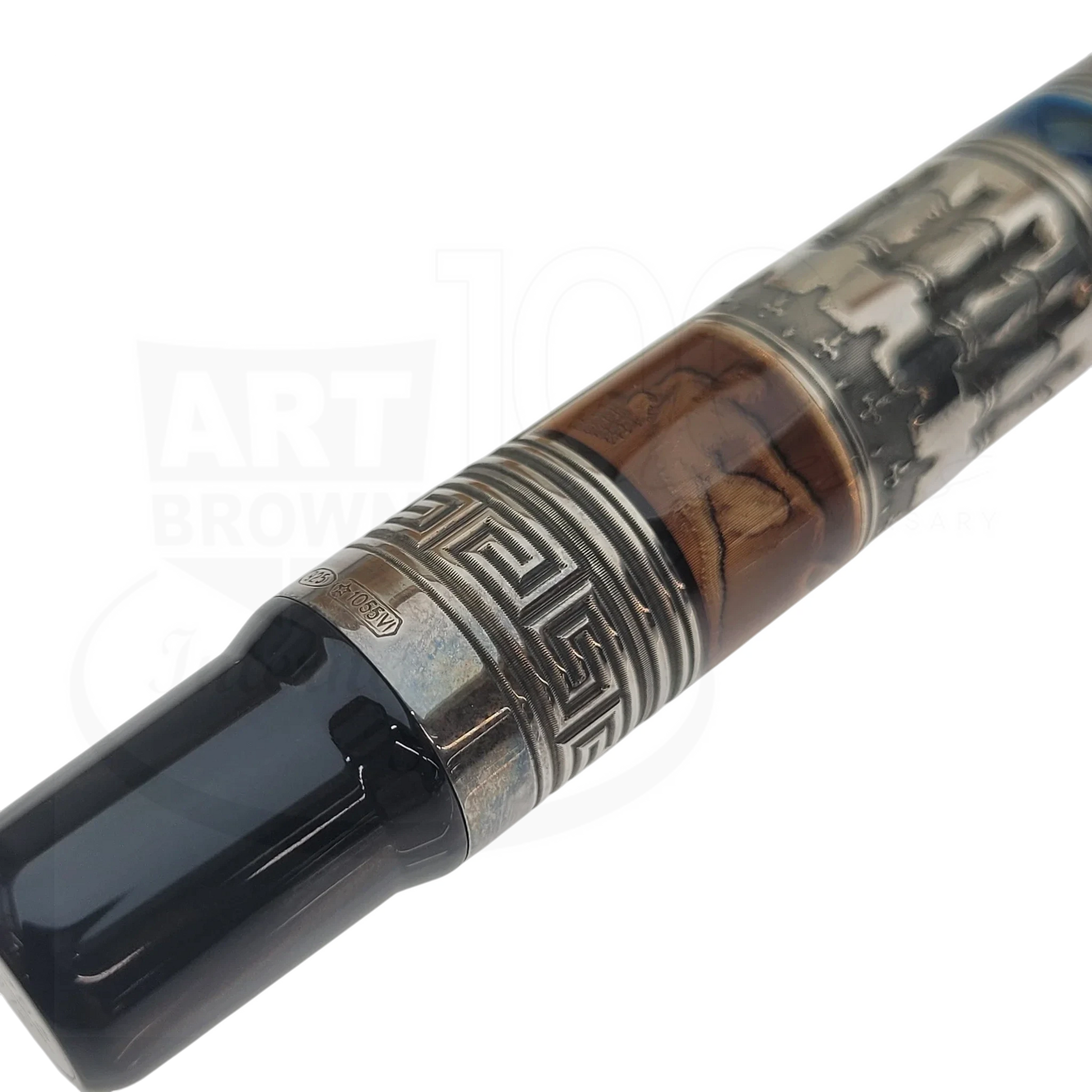 Close-up of a luxury fountain pen with intricate metal and wood detailing and a black glossy mouthpiece