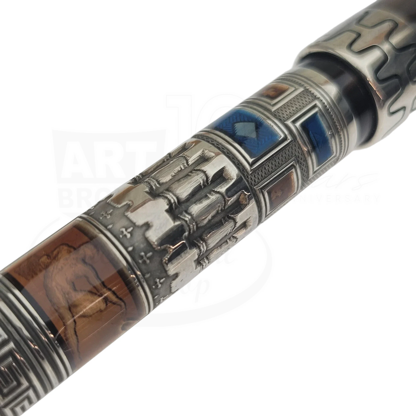 Close-up of detailed guilloche and engraved designs on a luxury fountain pen barrel with historical motifs.