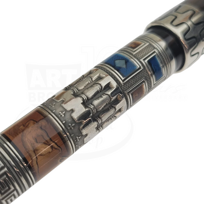 Close-up of detailed guilloche and engraved designs on a luxury fountain pen barrel with historical motifs.