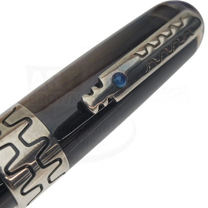 Close-up of luxury fountain pen clip with intricate metal design and dark polished barrel detail.