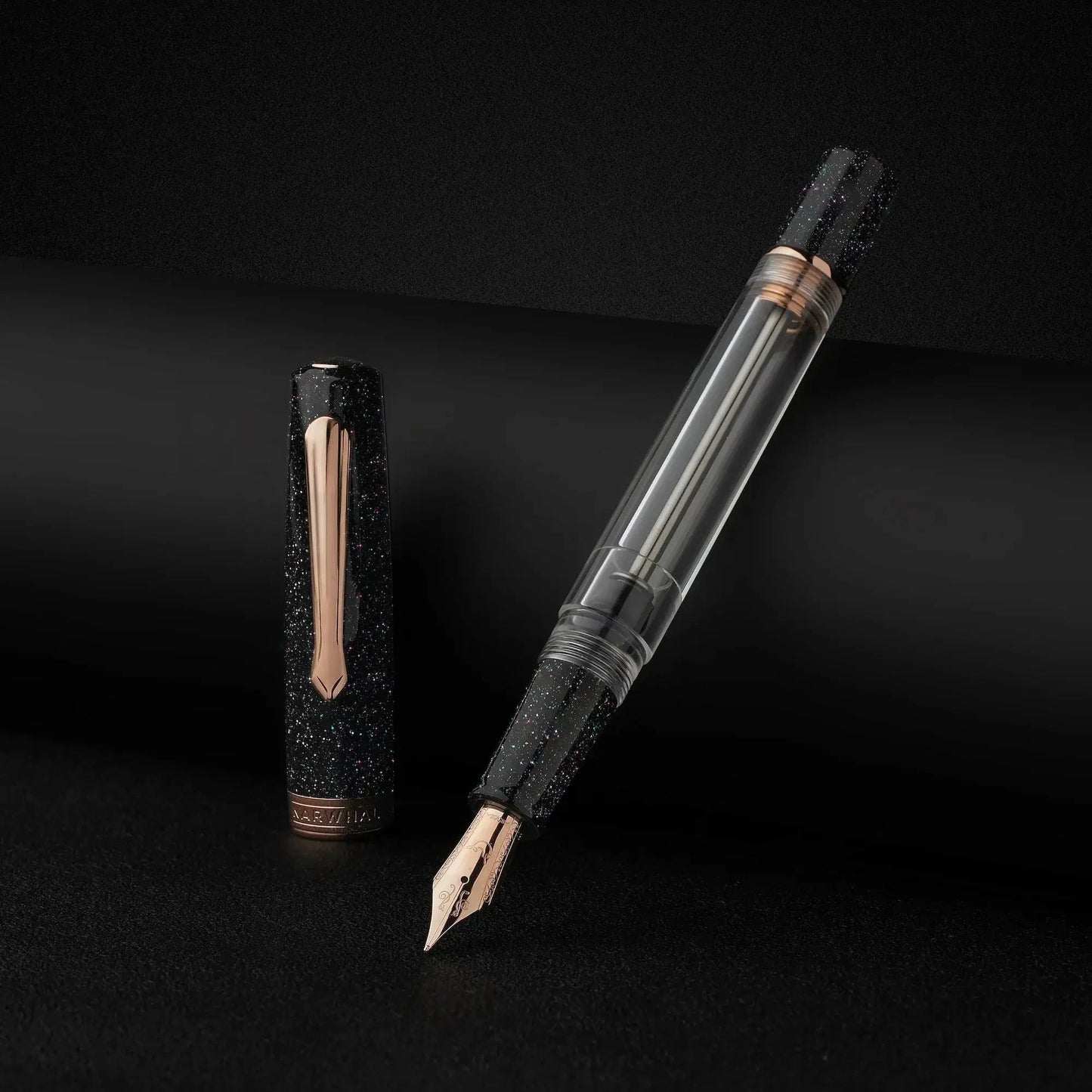 Nahvalur Original Plus Lovina graphite resin fountain pen with rose gold trim and transparent ink chamber, displayed with cap