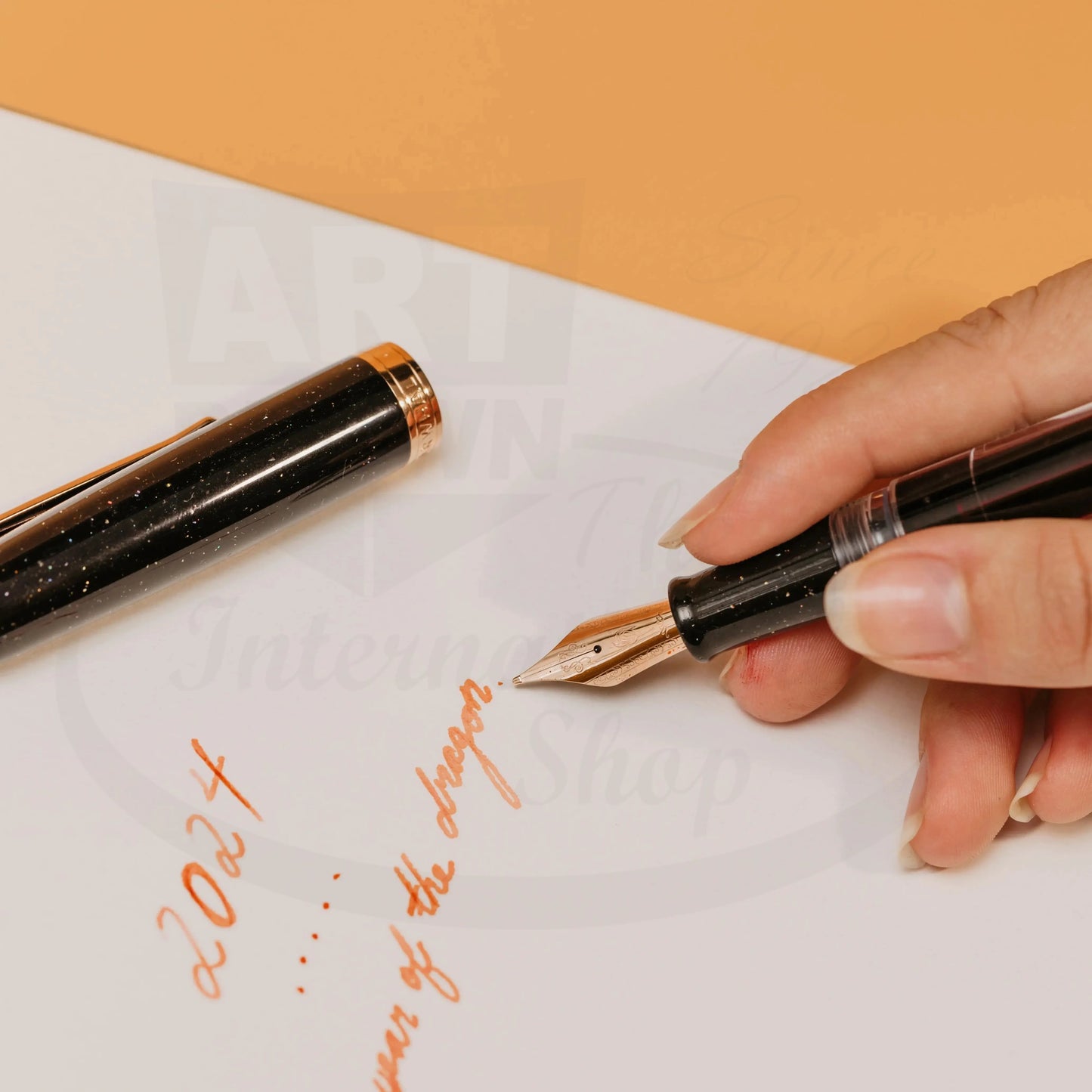 Nahvalur Original Plus Lovina Graphite resin fountain pen with rose gold trim, vacuum-fill system, writing on white paper