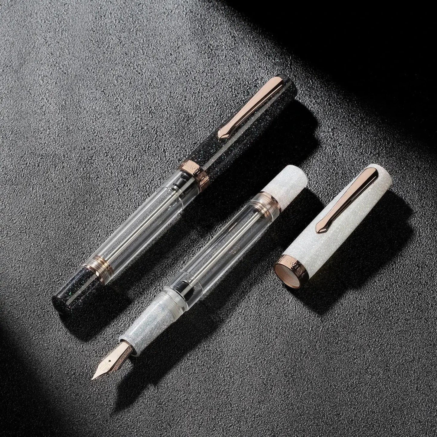Nahvalur Original Plus Lovina Graphite fountain pen in acrylic resin with rose gold trim, transparent ink chamber and cap shown disassembled