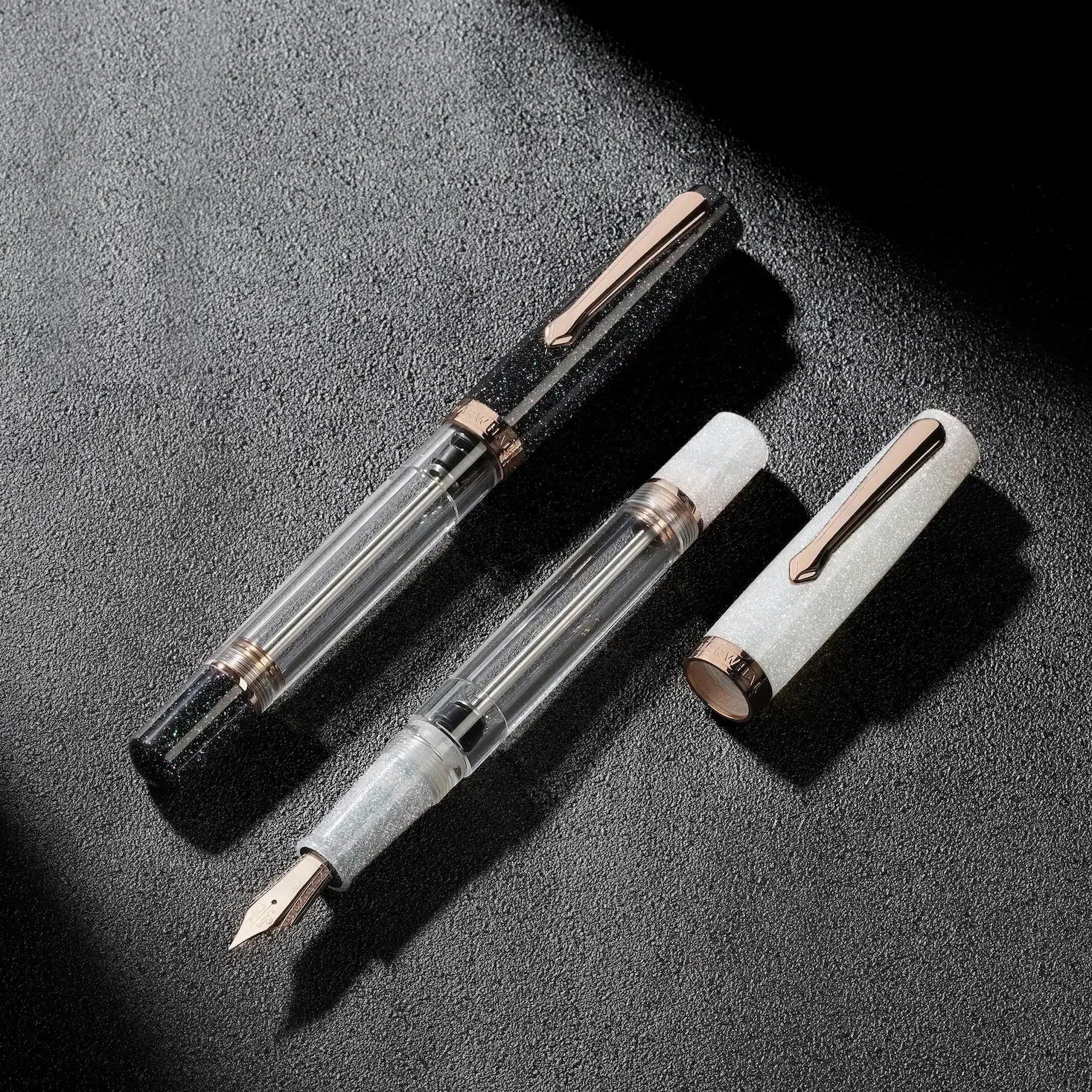 Nahvalur Original Plus Lovina Graphite fountain pen in acrylic resin with rose gold trim, transparent ink chamber and cap shown disassembled
