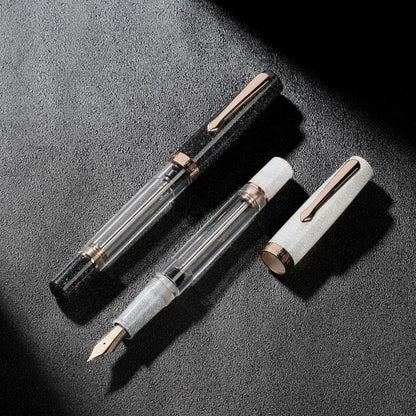 Nahvalur Original Plus Lovina Graphite fountain pen in acrylic resin with rose gold trim, transparent ink chamber and cap shown disassembled