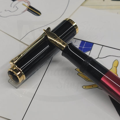 Pelikan Classic M200 827379 resin fountain pen with black cap, gold trims, and red barrel section showing nib detail