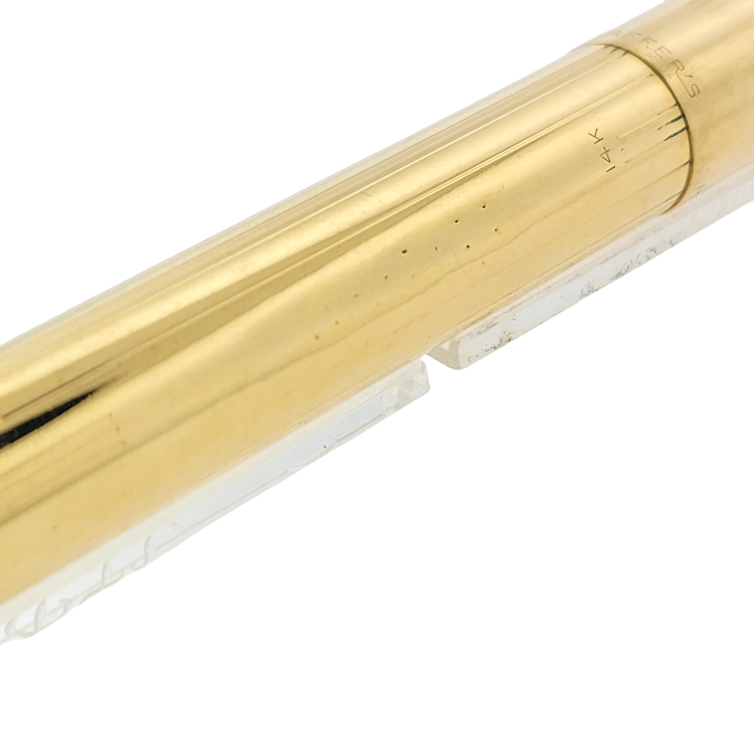 Sheaffer Snorkel fountain pen in solid 14K gold with vertical line pattern, polished finish, and gold nib marking