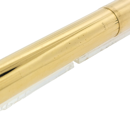 Sheaffer Snorkel fountain pen in solid 14K gold with vertical line pattern, polished finish, and gold nib marking