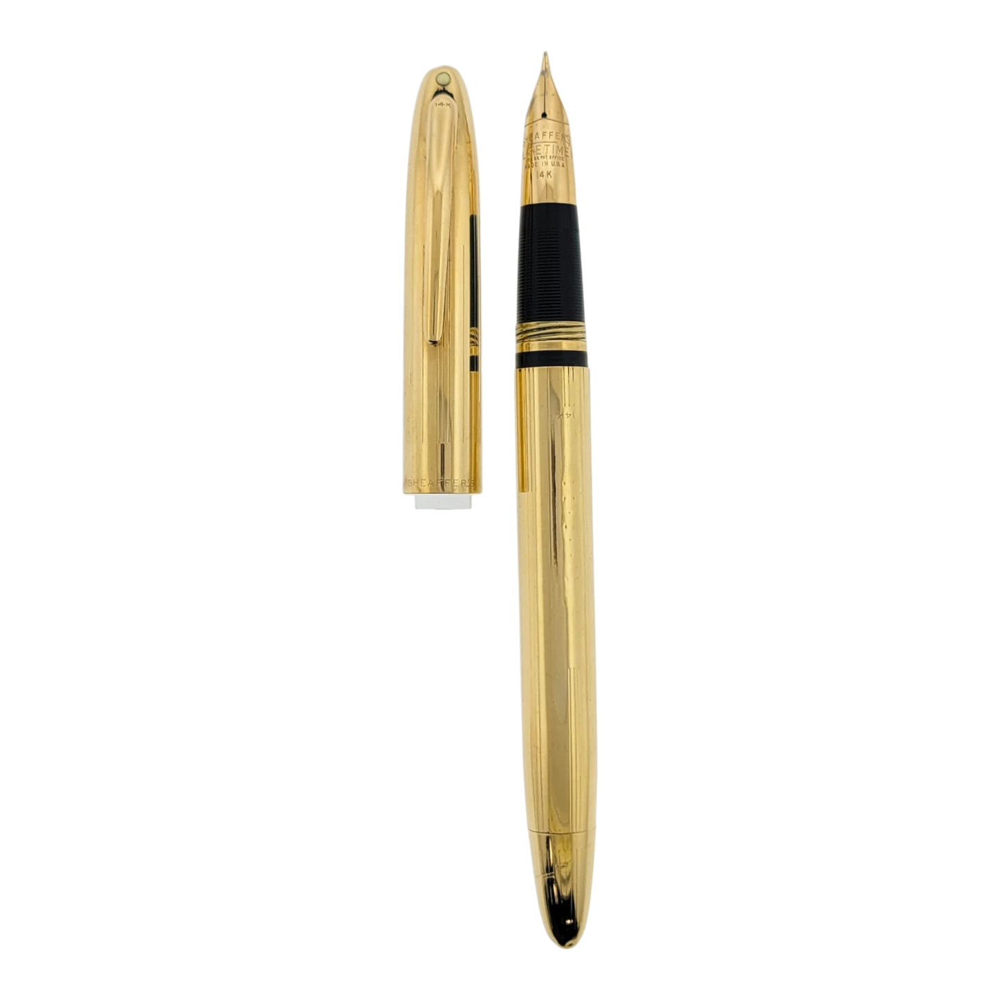 Sheaffer Snorkel fountain pen with solid 14K gold body featuring vertical line engraving and gold nib visible