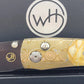 Detailed view of the William Henry B7 knife's Mokume-Gane frame and lock button adorned with white topaz, set against the dark interior of the box