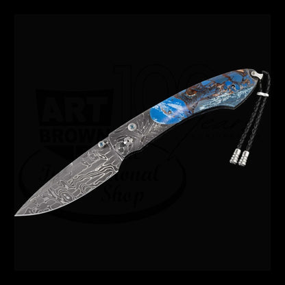 William Henry B12 Blue Fusion spearpoint knife with Damascus steel blade and blue fossil mammoth tusk handle with braided leather pull tabs