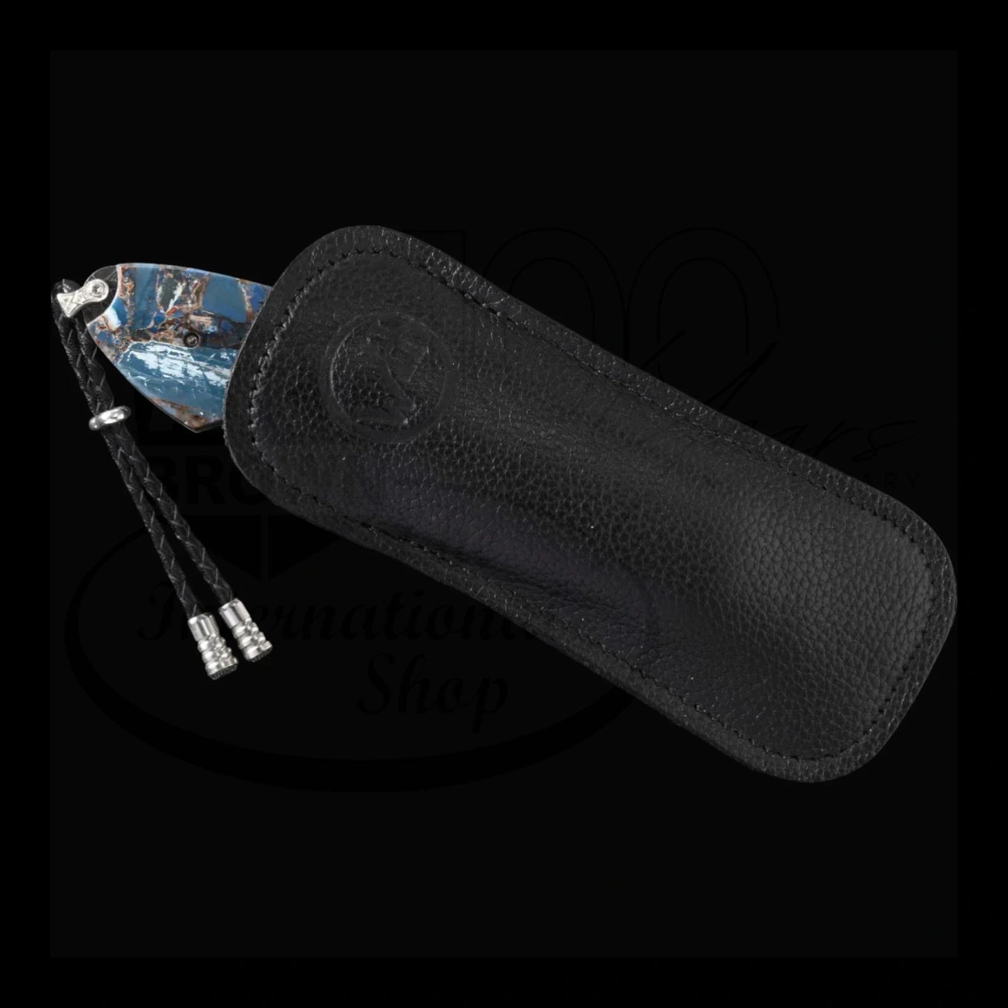William Henry B12 Blue Fusion Spearpoint with blue fossilized mammoth tusk blade and black leather sheath with braided leather pull tabs