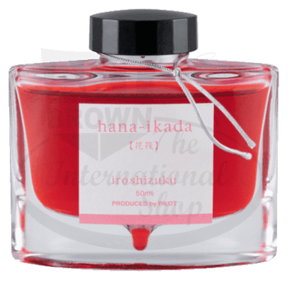 Pilot Iroshizuku glass bottle fountain pen ink in vibrant coral red, 50ml size with black screw cap and Japanese label