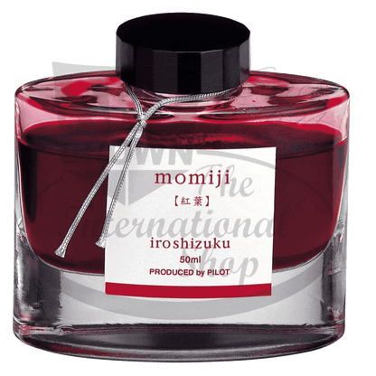 Pilot Iroshizuku glass bottled ink in Momiji red, 50ml size with black cap and silver ribbon, featuring elegant Japanese calligraphy label